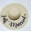 Natural wide brimmed sun hat with black “Just Married” script – perfect honeymoon and bride to be accessory.