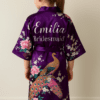 Flower girl wearing a personalised satin robe with peacock design
