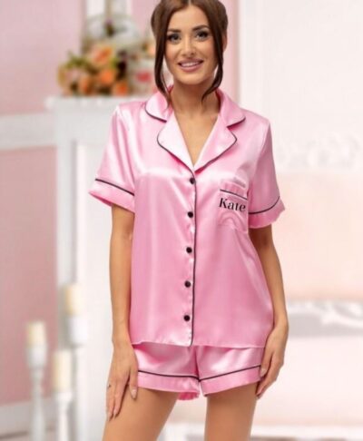 Bride wearing personalised pink satin short pyjamas with monogram text